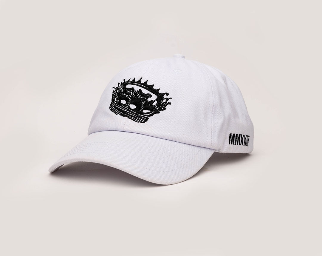 A white coloured, one-size-fits-all 6-panel, unsctructured cap, made of 100% cotton, with a heavy enzyme wash finish. Featuring the Rubberband Sovereign detailed "crowned" logo embroidered in black on the front. 