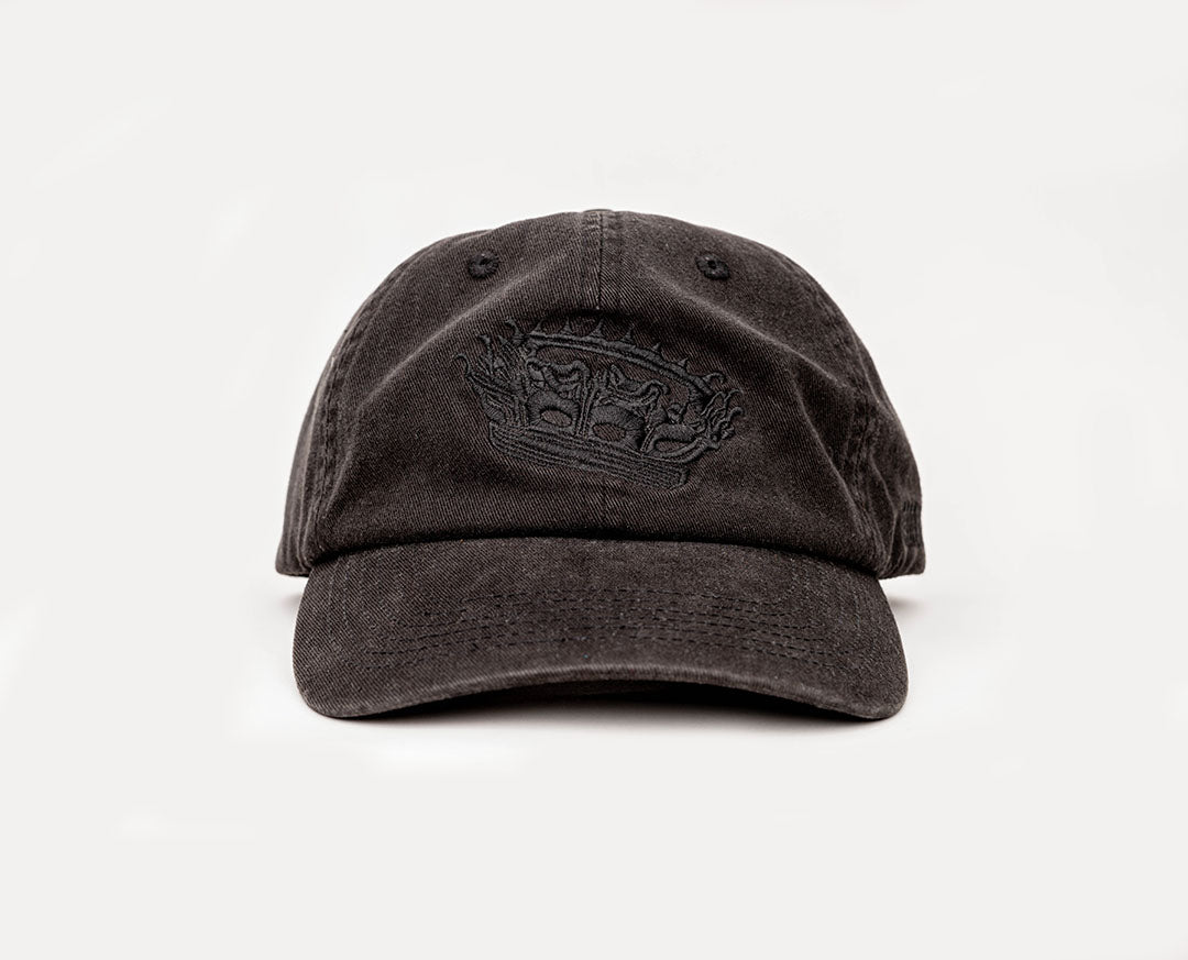 A black coloured, one-size-fits-all 6-panel, unsctructured cap, made of 100% cotton, with a heavy enzyme wash finish. Featuring the Rubberband Sovereign detailed "crowned" logo embroidered in black on the front. 