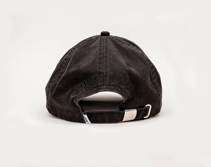 A black coloured, one-size-fits-all 6-panel cap, made of 100% cotton. The back of the cap has the RUBBERBAND SOVEREIGN black embroidery above the opening, and a metal clasp closure  for an adjustable fit, with a low profile unstructured design enhancing its casual, laid-back look.